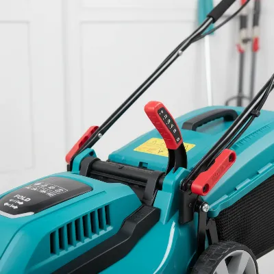 A close-up of a compact electric lawn mower highlighting its adjustable cutting height lever and foldable handle.